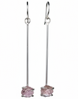 Pair of long earrings with raw ametrine gemstones on a white background