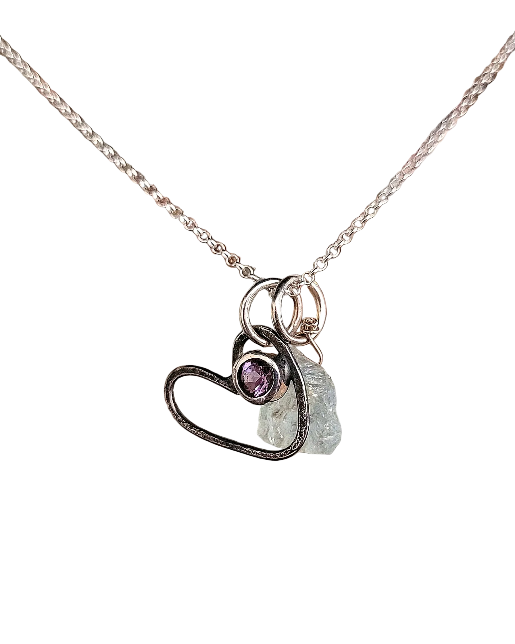 Necklace with heart-shaped pendant featuring a purple gemstone and gray stone on a white background