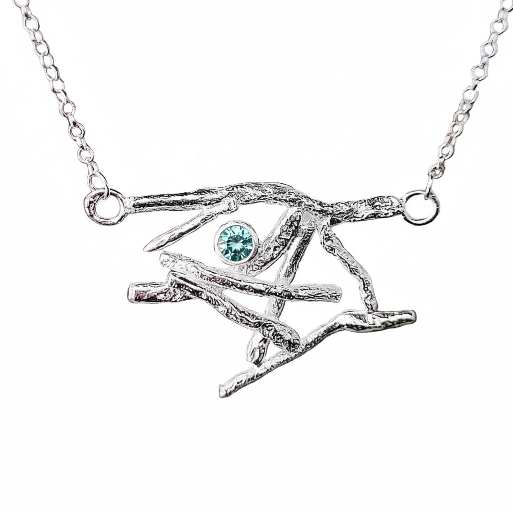 Silver necklace with an eye-shaped pendant featuring a purple gemstone on a white background