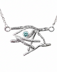 Silver necklace with an eye-shaped pendant featuring a purple gemstone on a white background