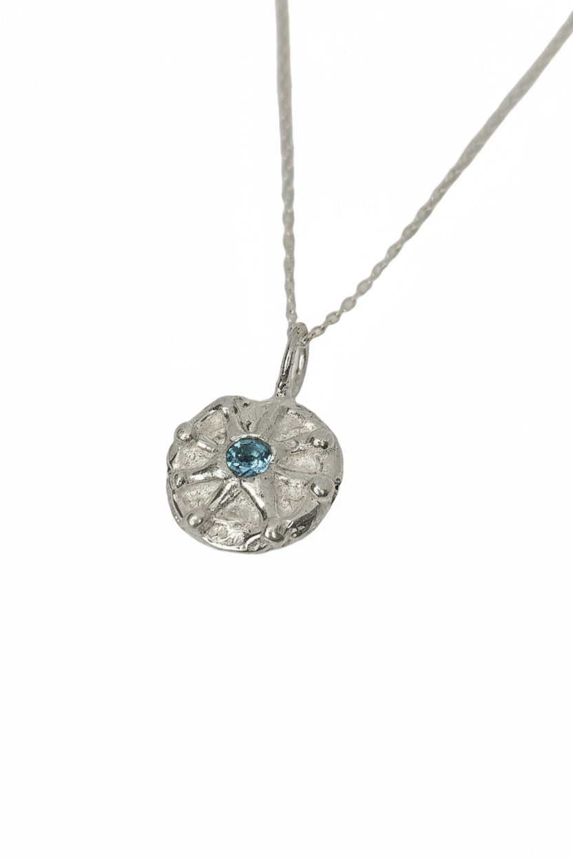 Silver necklace with a round pendant featuring a blue topaz gemstone, unique necklace, belfast city, pagan jewellery, bohemian inspired