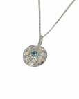 Silver necklace with a round pendant featuring a blue topaz gemstone, unique necklace, belfast city, pagan jewellery, bohemian inspired